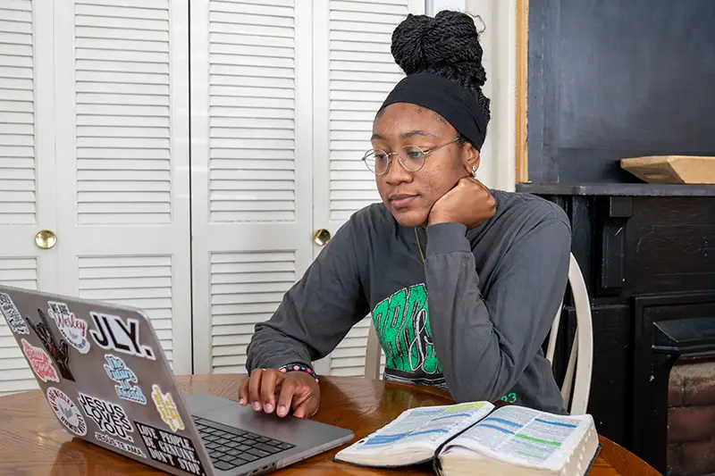 IWU online student on laptop