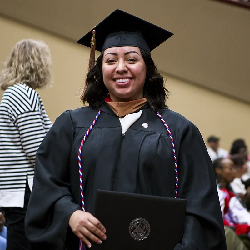 IWU graduate with diploma