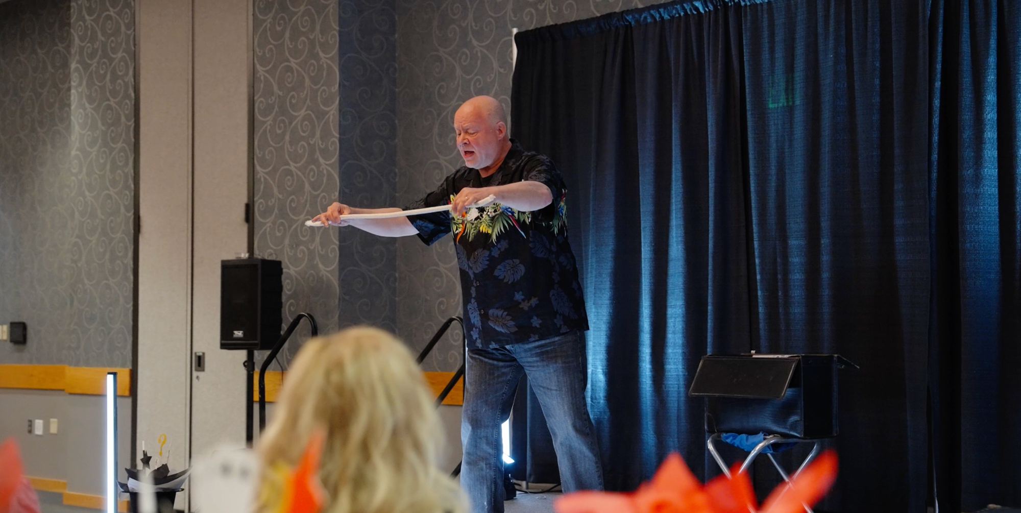 Larry Wirtz doing a magic trick in front of a crowd
