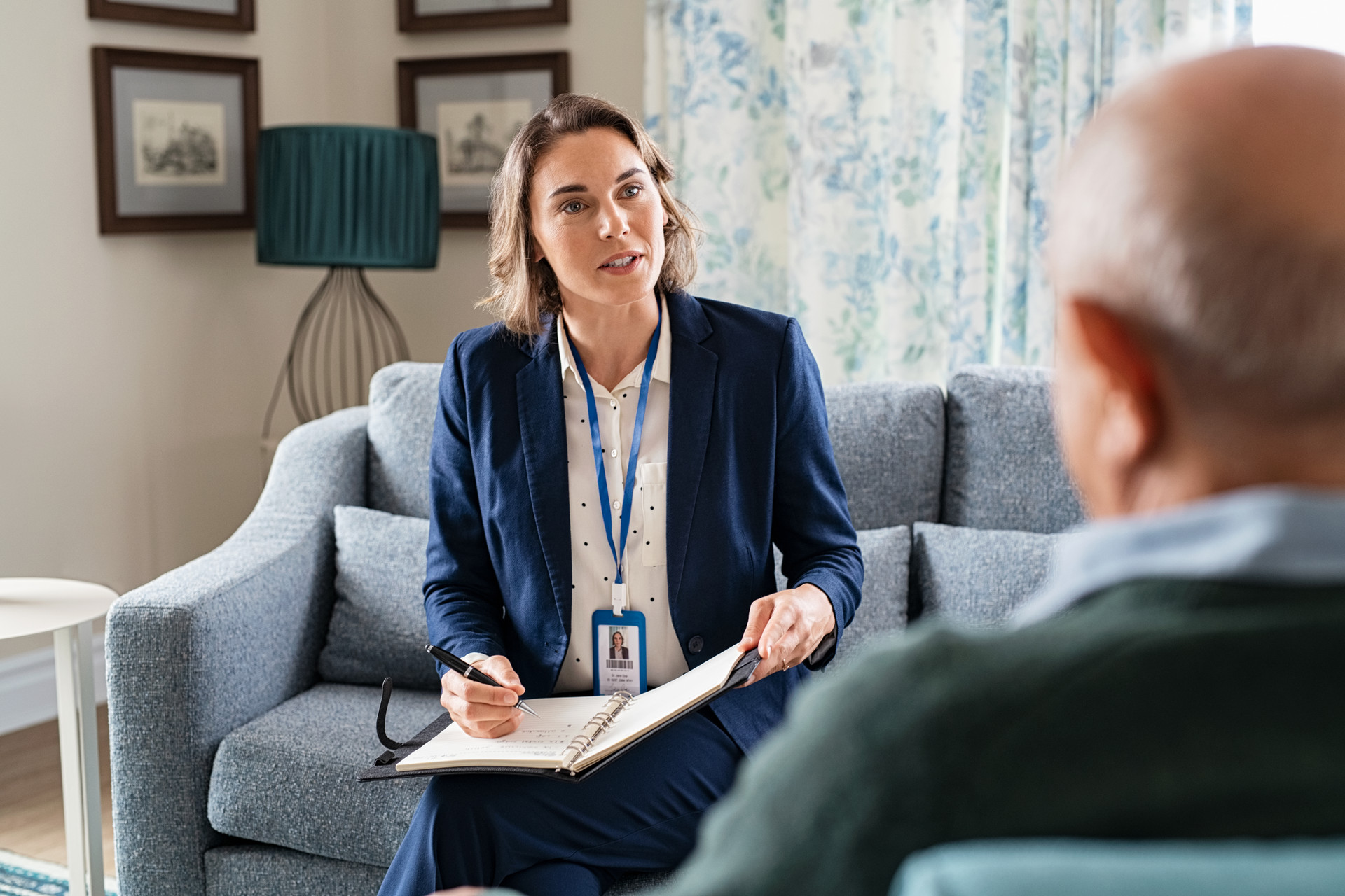 Social worker on a couch, talking to a man