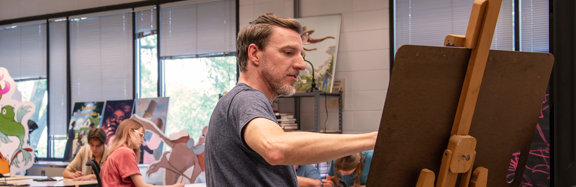 Keith Lowe painting at an easel